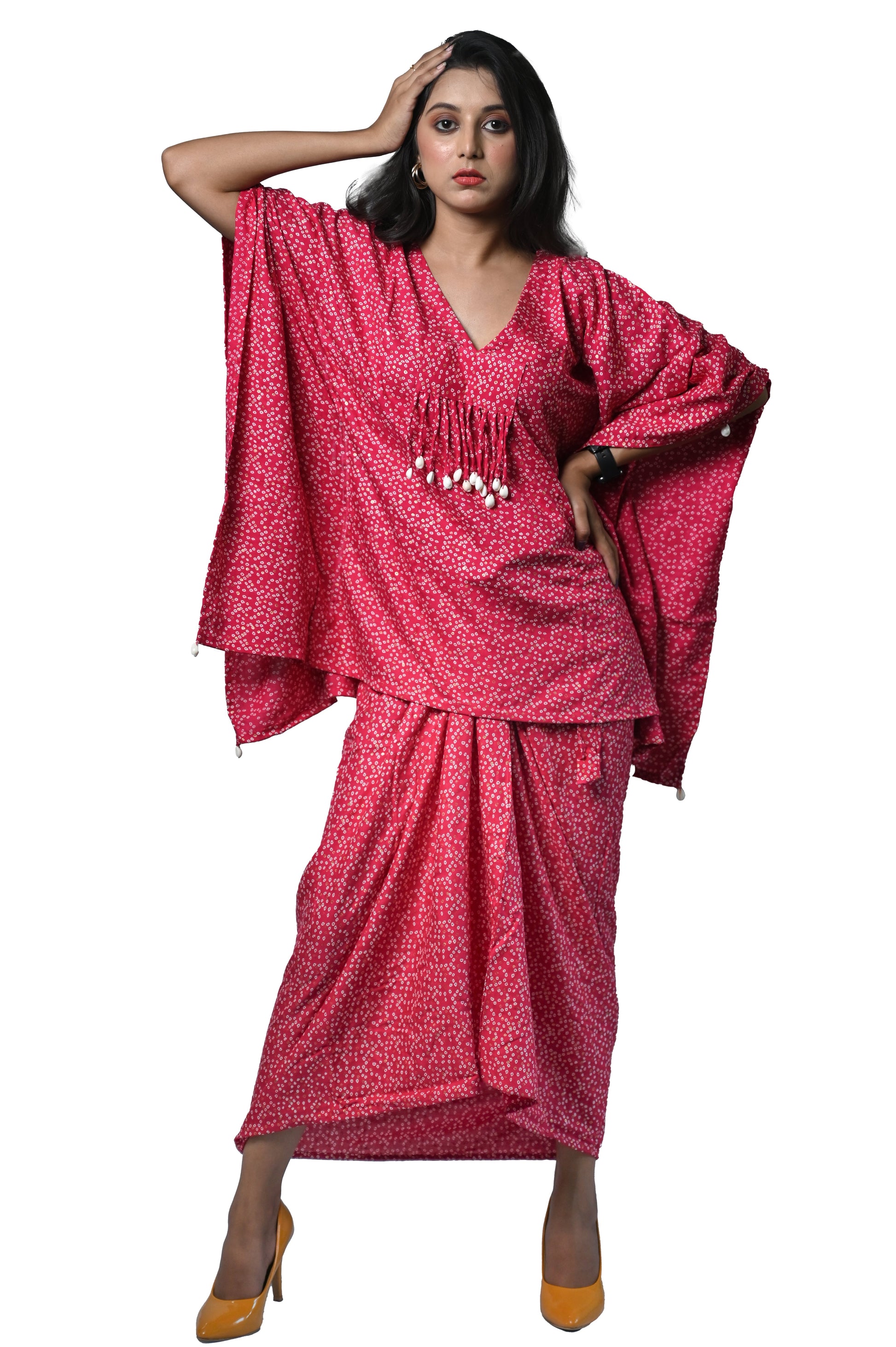 Model showcasing a stunning pink Bandhani Dhoti dress with intricate patterns, perfect for ethnic elegance.