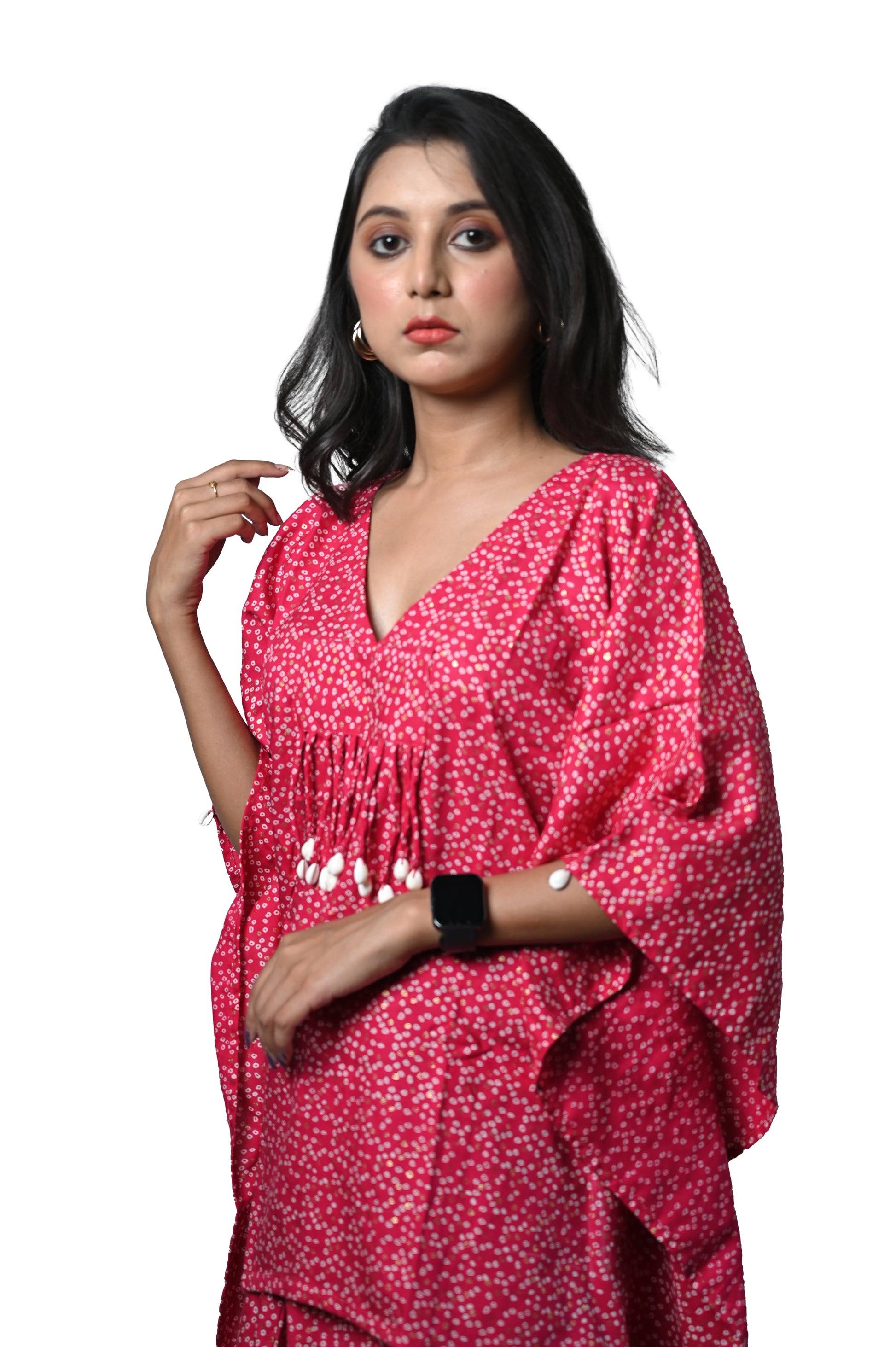 Woman wearing a vibrant pink Bandhani dhoti dress, showcasing elegance and traditional Indian craftsmanship.