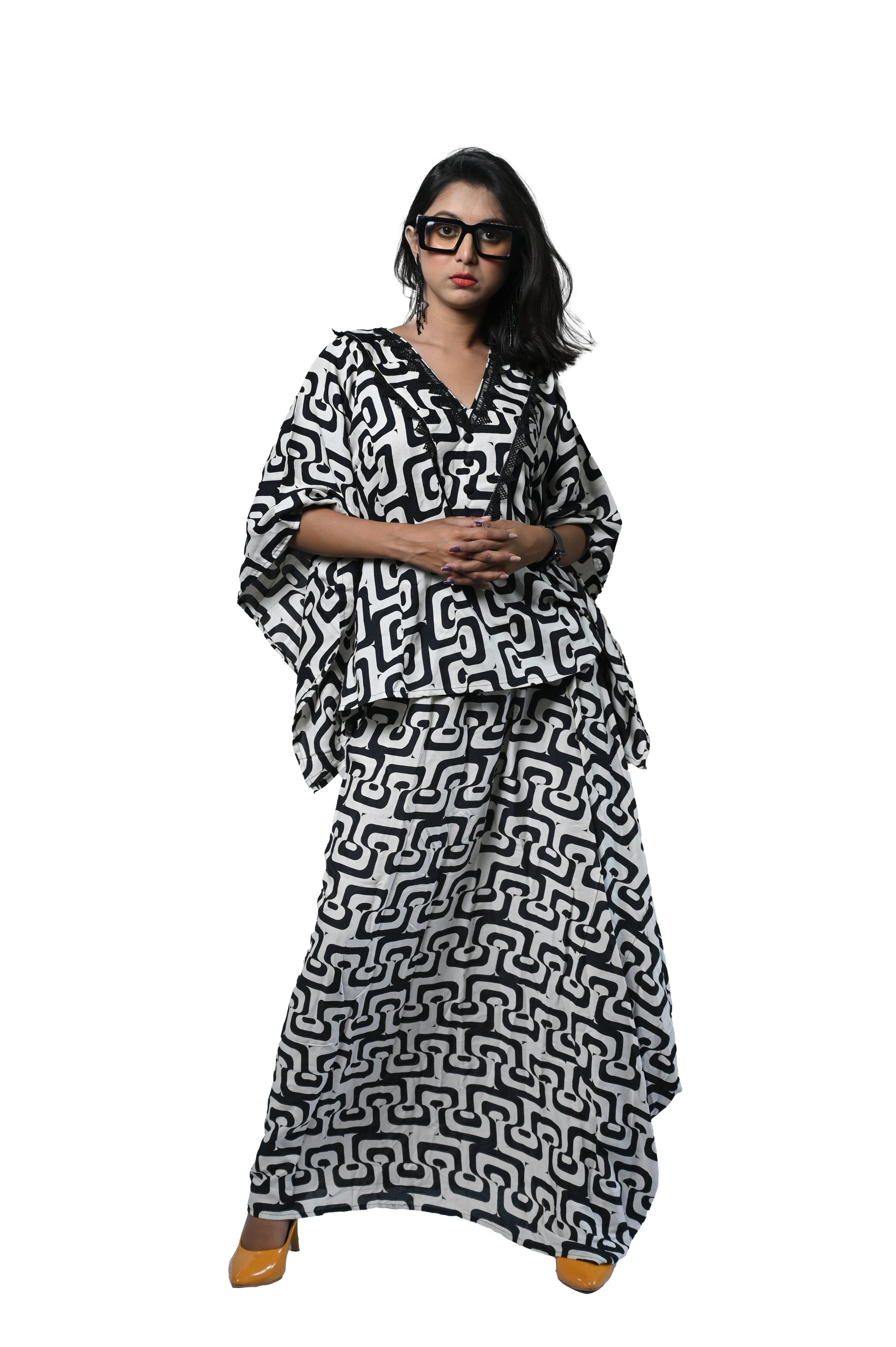 Black and white bold print dhoti set featuring a stylish kaftan kurta, embodying sophistication and contemporary flair.