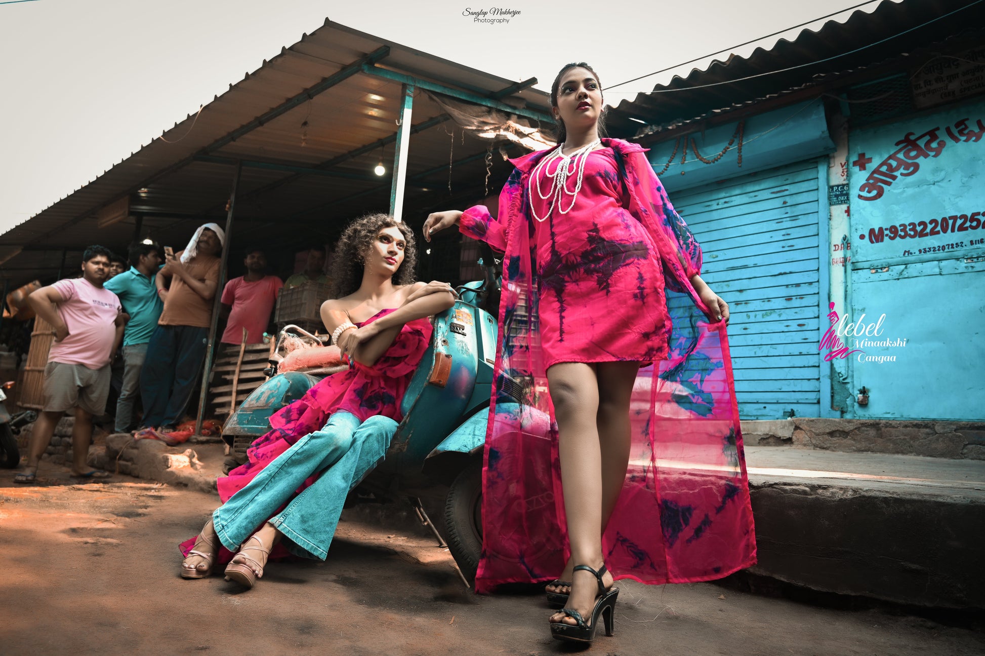 Model wearing pink organza tie and dye beach dress with long shrug, posing in vibrant outdoor setting.
